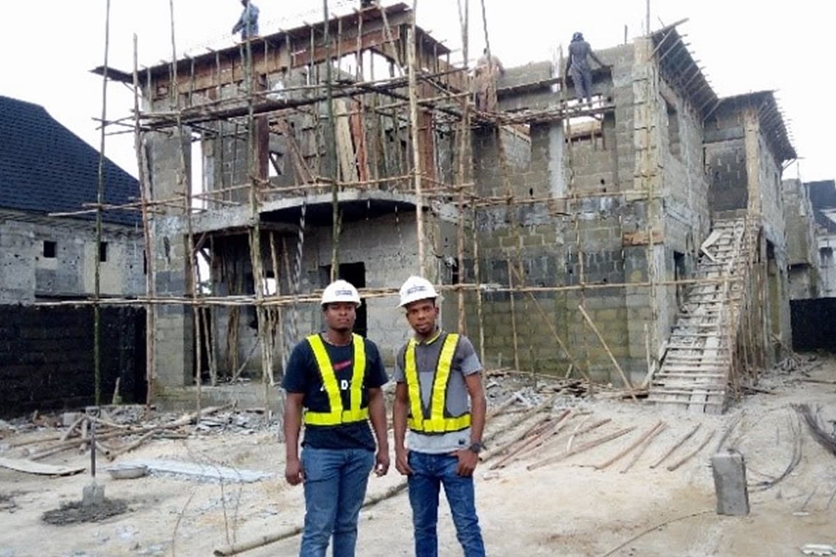 Temamost Nigeria Ltd's construction management team reviewing project plans on-site, ensuring effective project coordination and oversight.